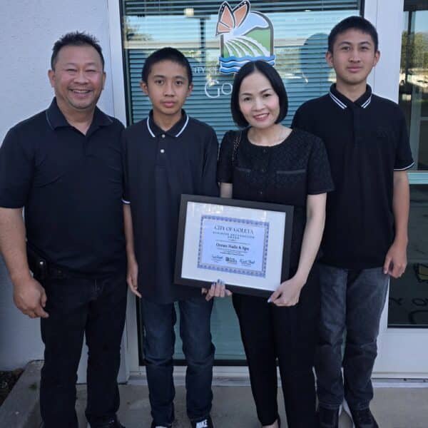 Ocean Nails & Spa owner Kathy Bui with her family outside of City Council Chambers