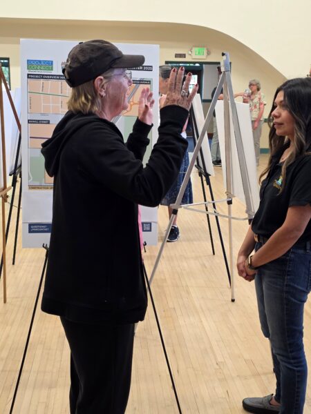 Community member discussing with staff member
