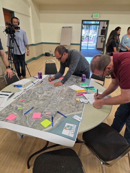 Community members gathered around map