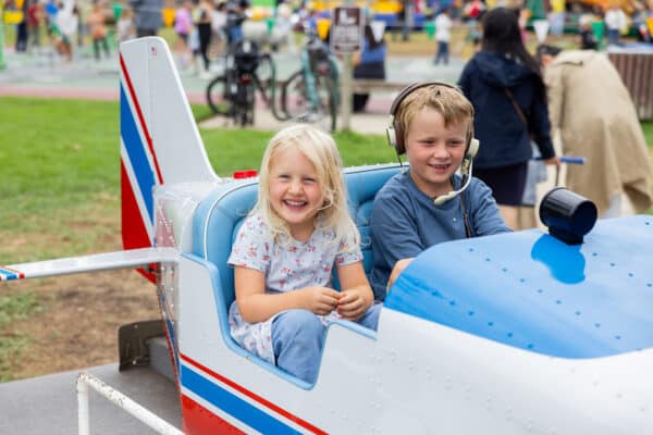 Kids in an airplane ride at the Lemon Festival