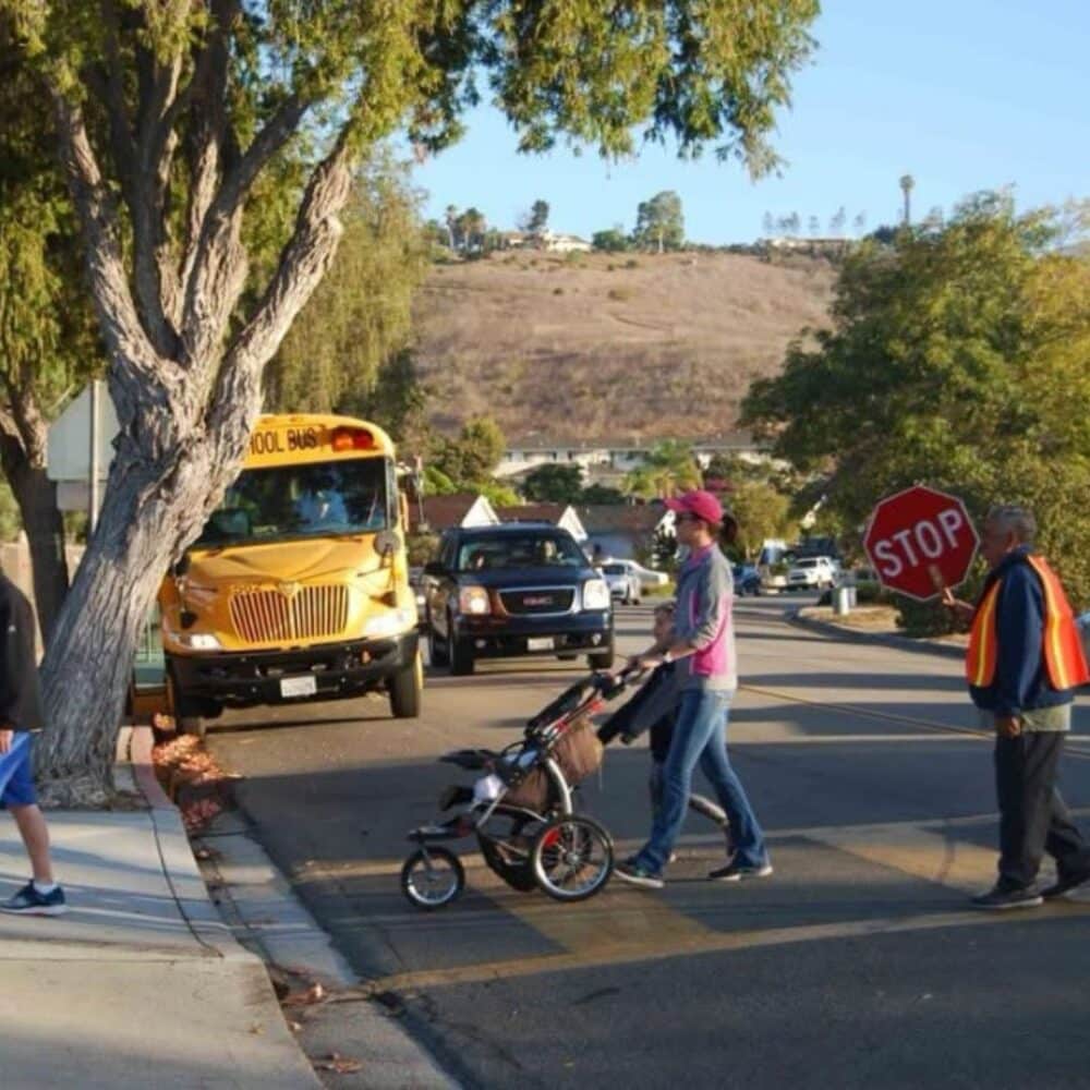 Brandon School crosswalk with crossing guard and pedestrian