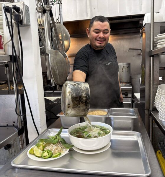 Saigon Noodle House chef putting the finishing touches on a meal